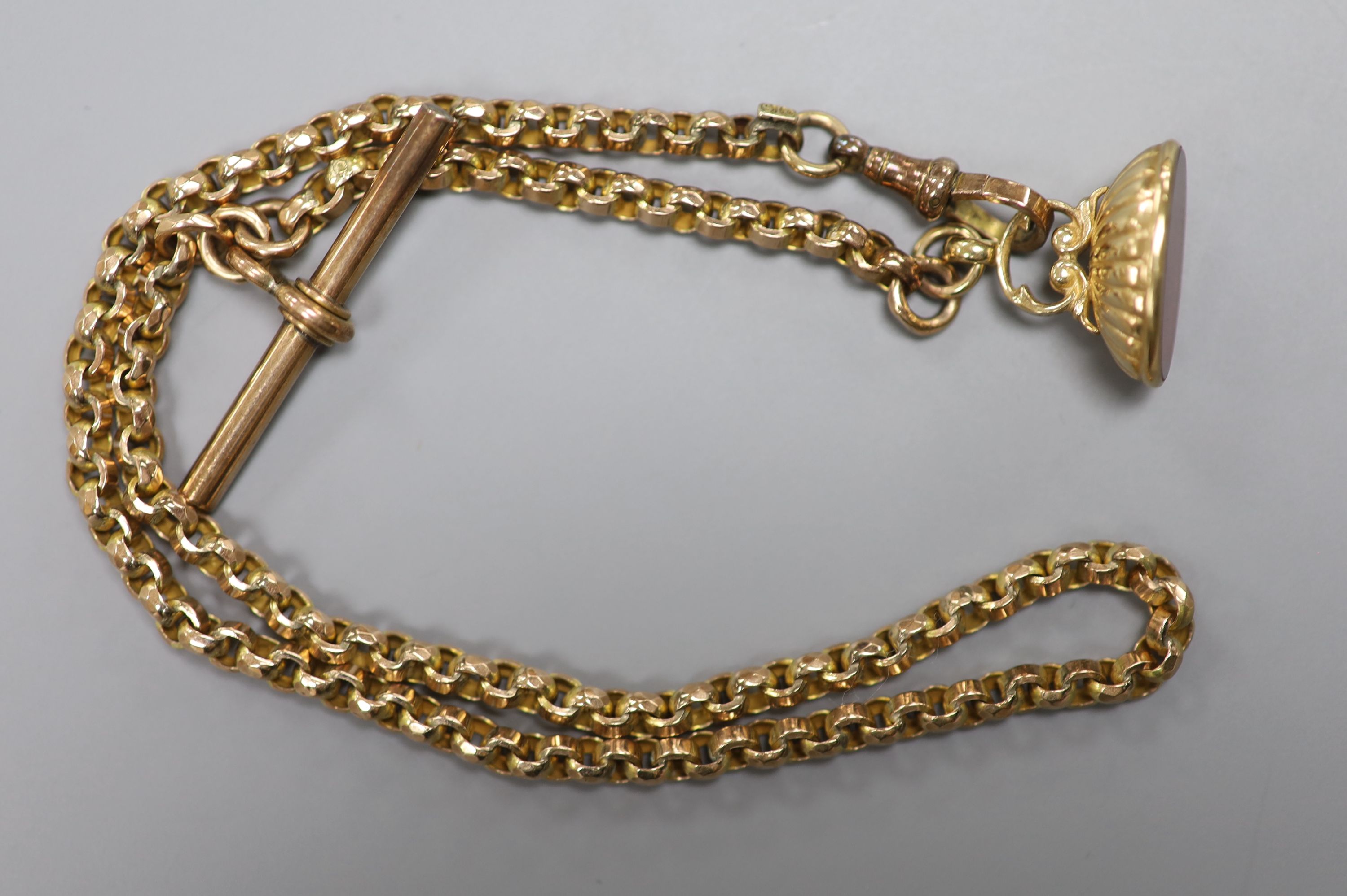 A late Victorian yellow metal (stamped 9c) albert chain, hung with a modern 9ct gold and carnelian? set fob seal, 36cm.
